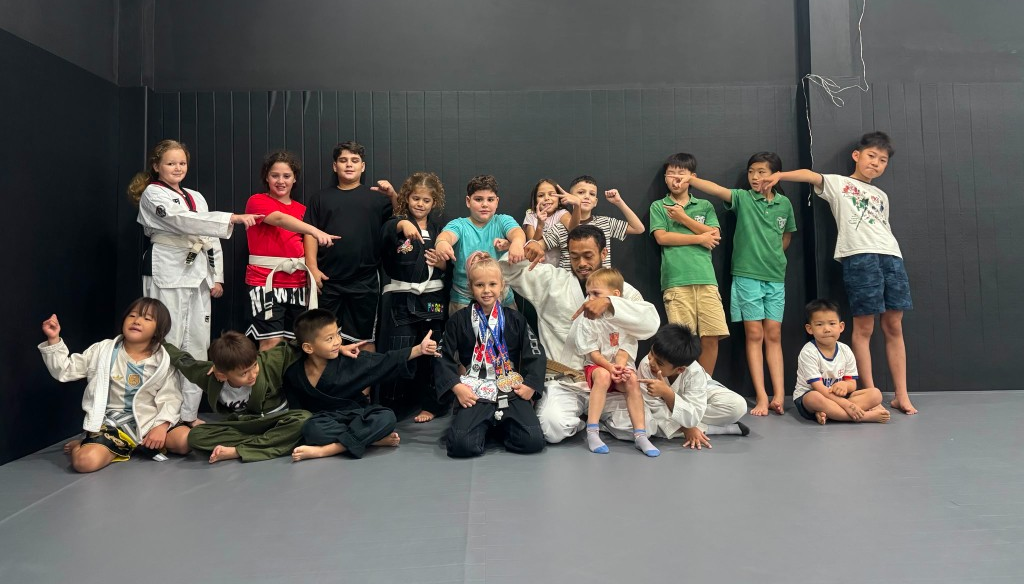 Lions Kids BJJ class celebrating a student with gi and no-gi silver medals coached by Brindy Mason